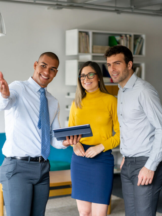 Real Estate Agent showing a property to a happy couple